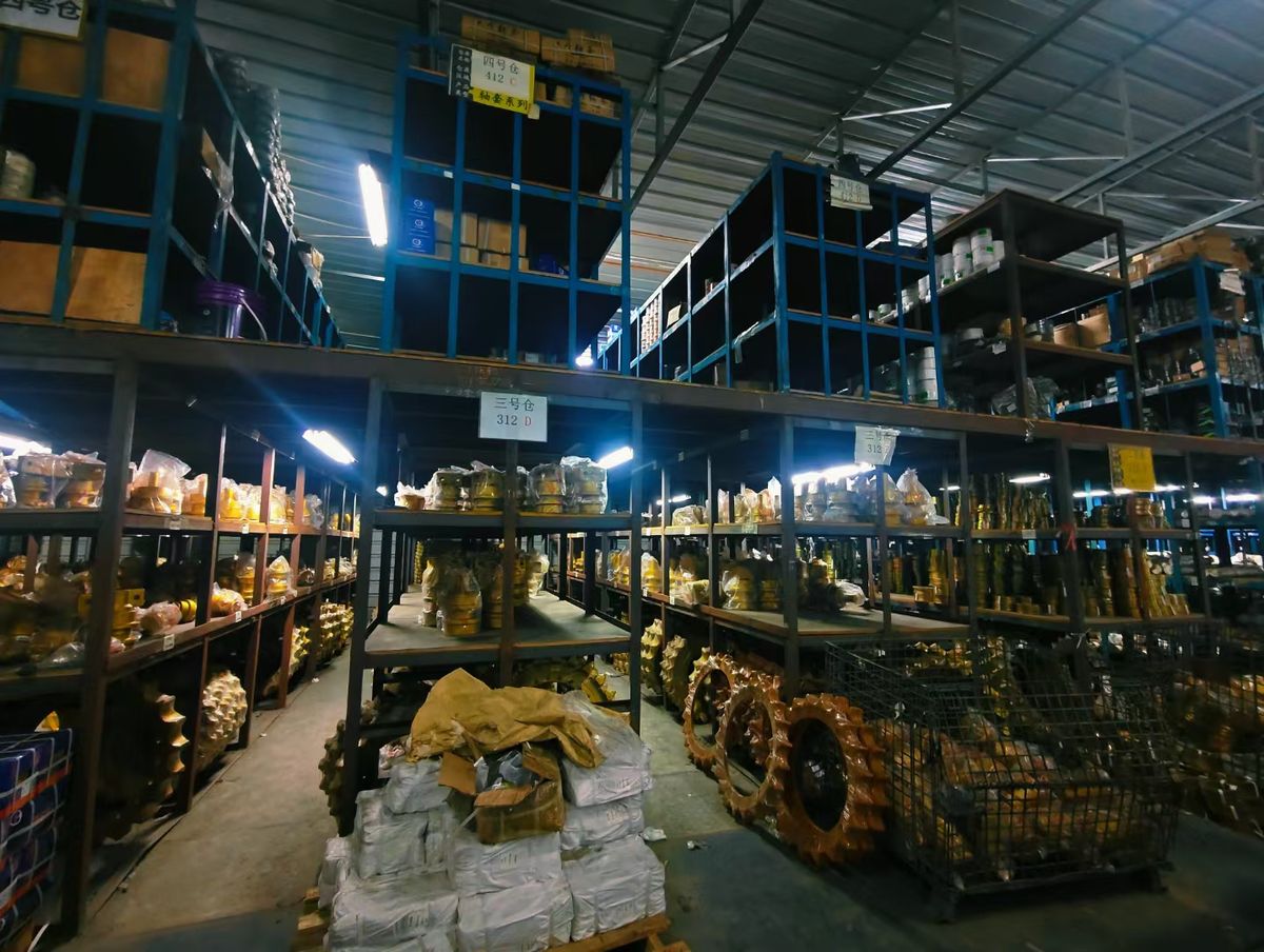 Shenyue warehouse racks stocked with Kobelco undercarriage and drivetrain parts